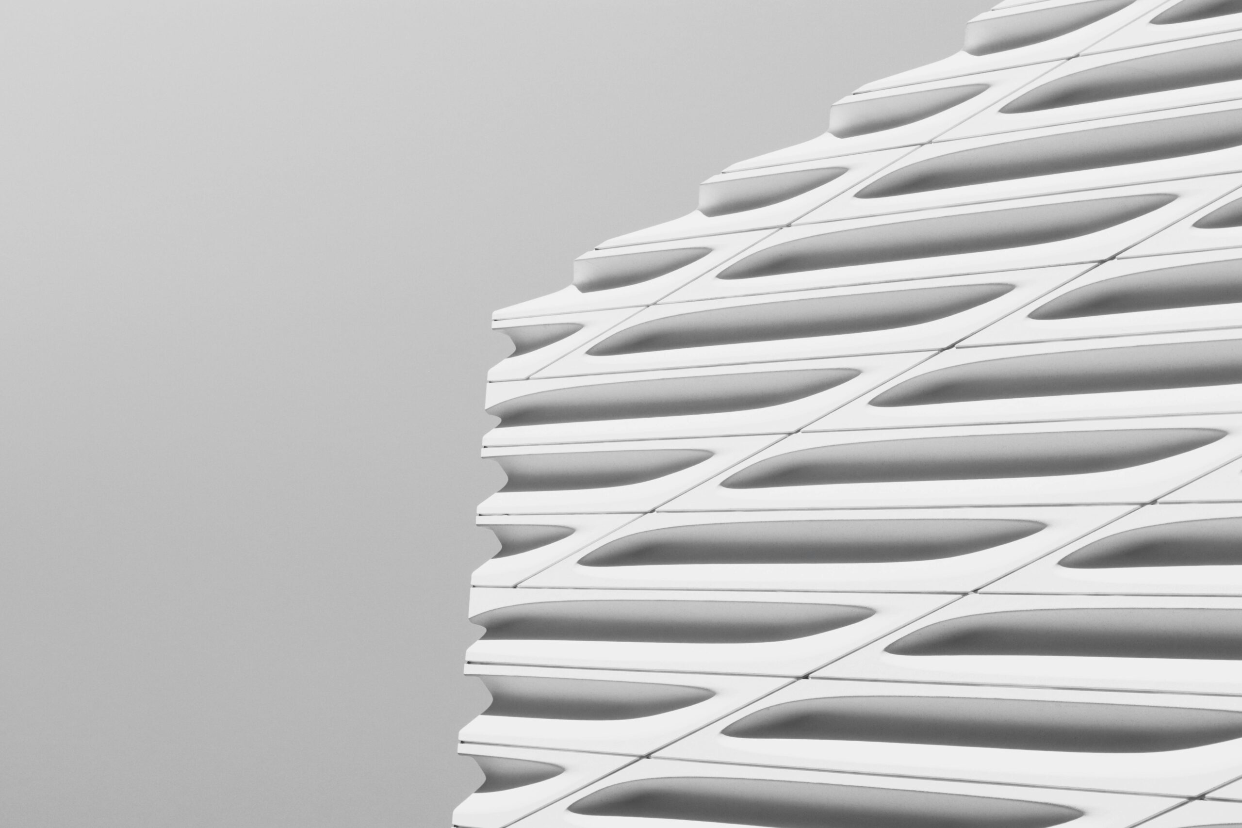 Close-up of a modern building's facade showcasing sleek, geometric architectural design.